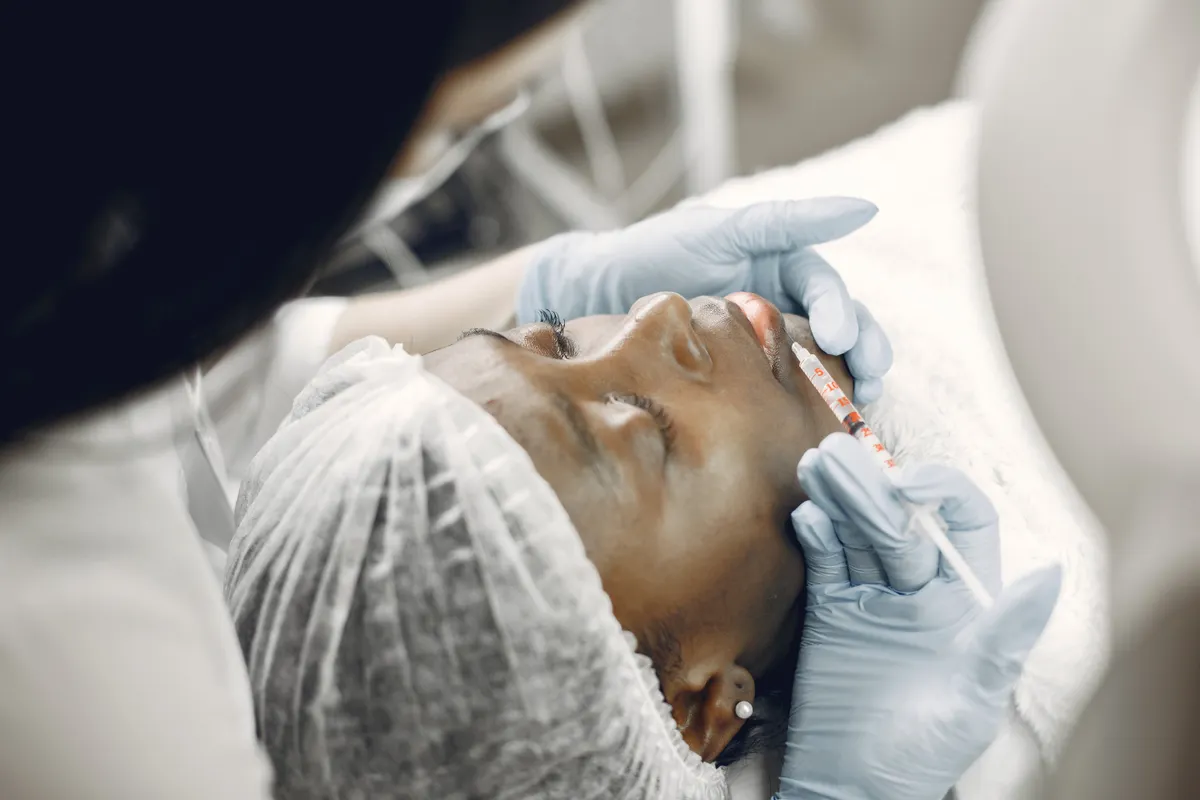 A specialist administering a lip injection